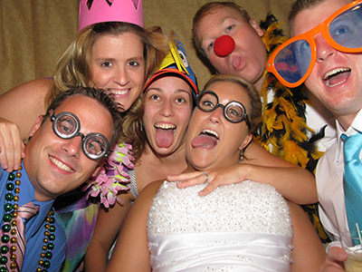 bride in photo booth with friends
